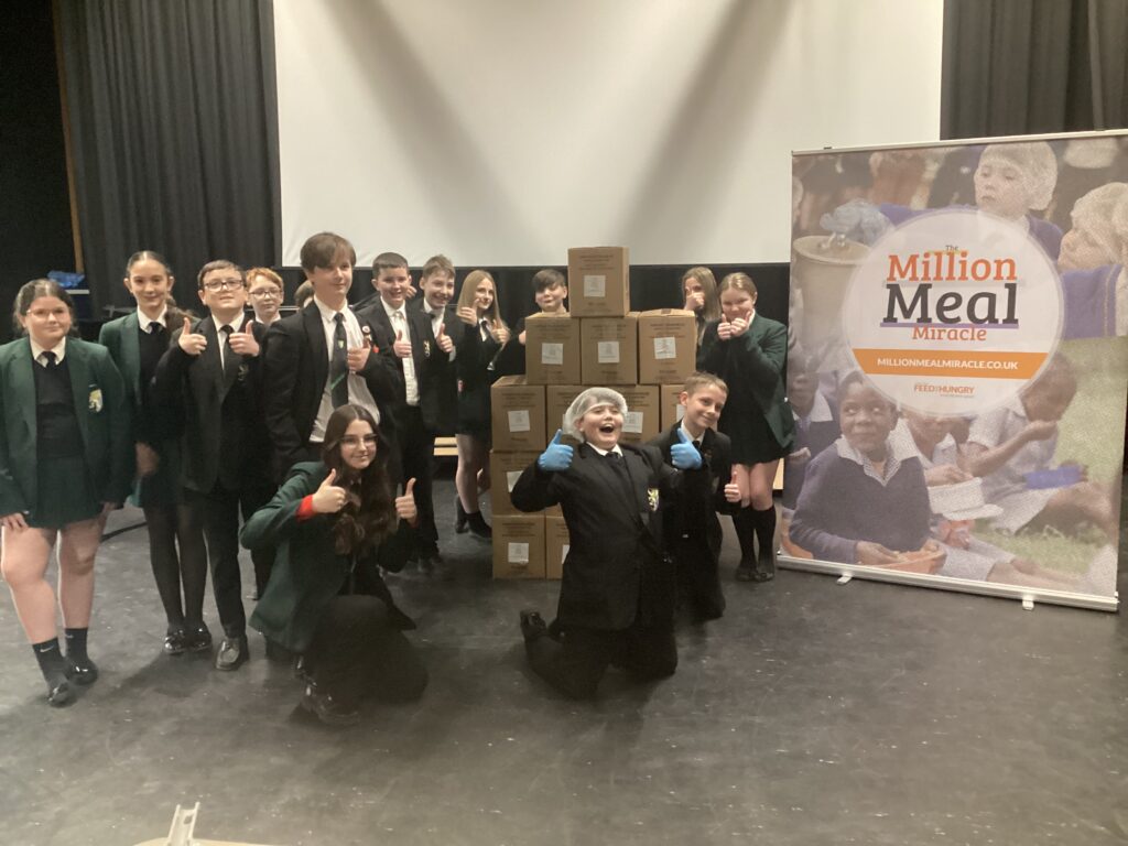 Students pack over 7,000 meals for people in need